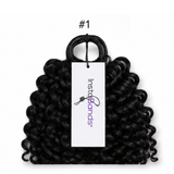 Black hair tie with a visible brand tag on a white background
